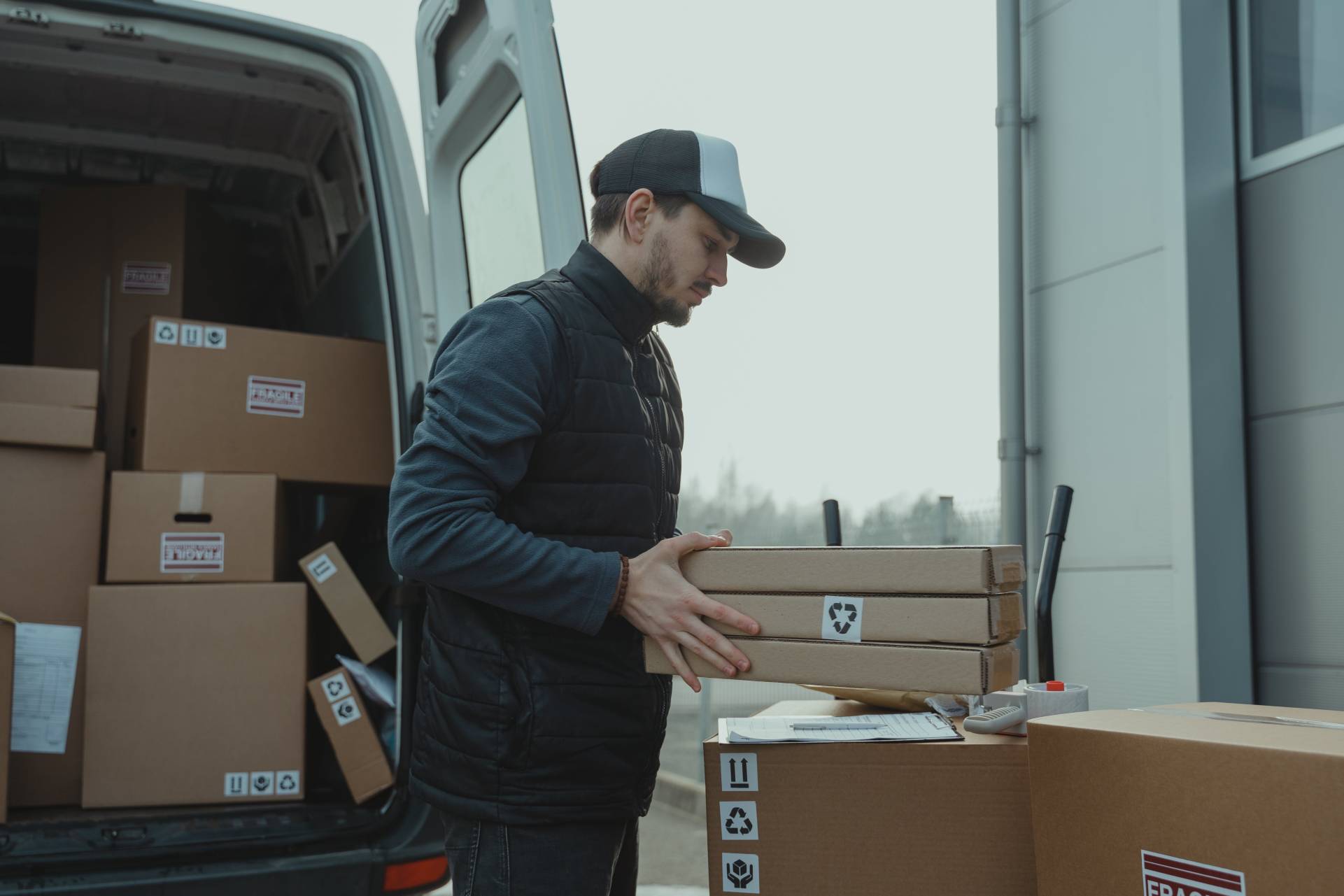 Man loading packages into the back of a truck